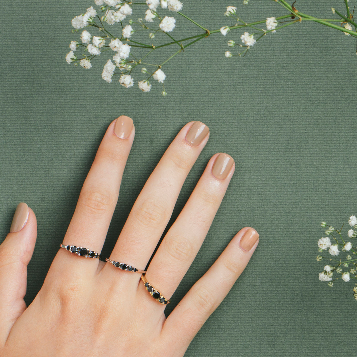 A gold ring set with 5 black diamonds, 60 points, inlaid with teeth