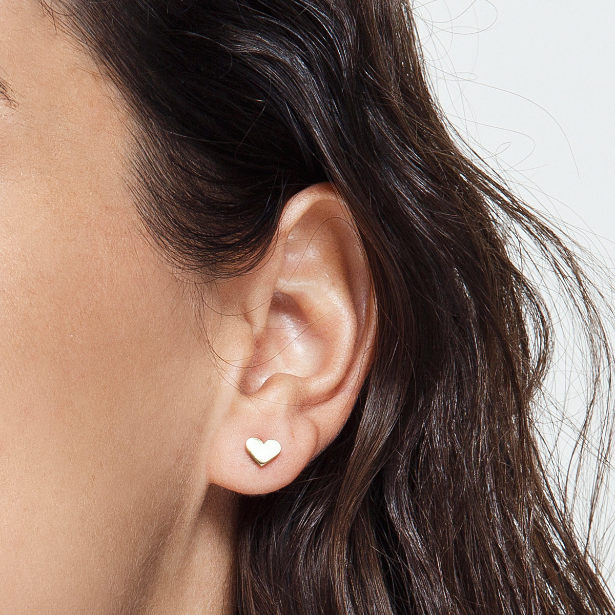 Gold earrings in the shape of a heart