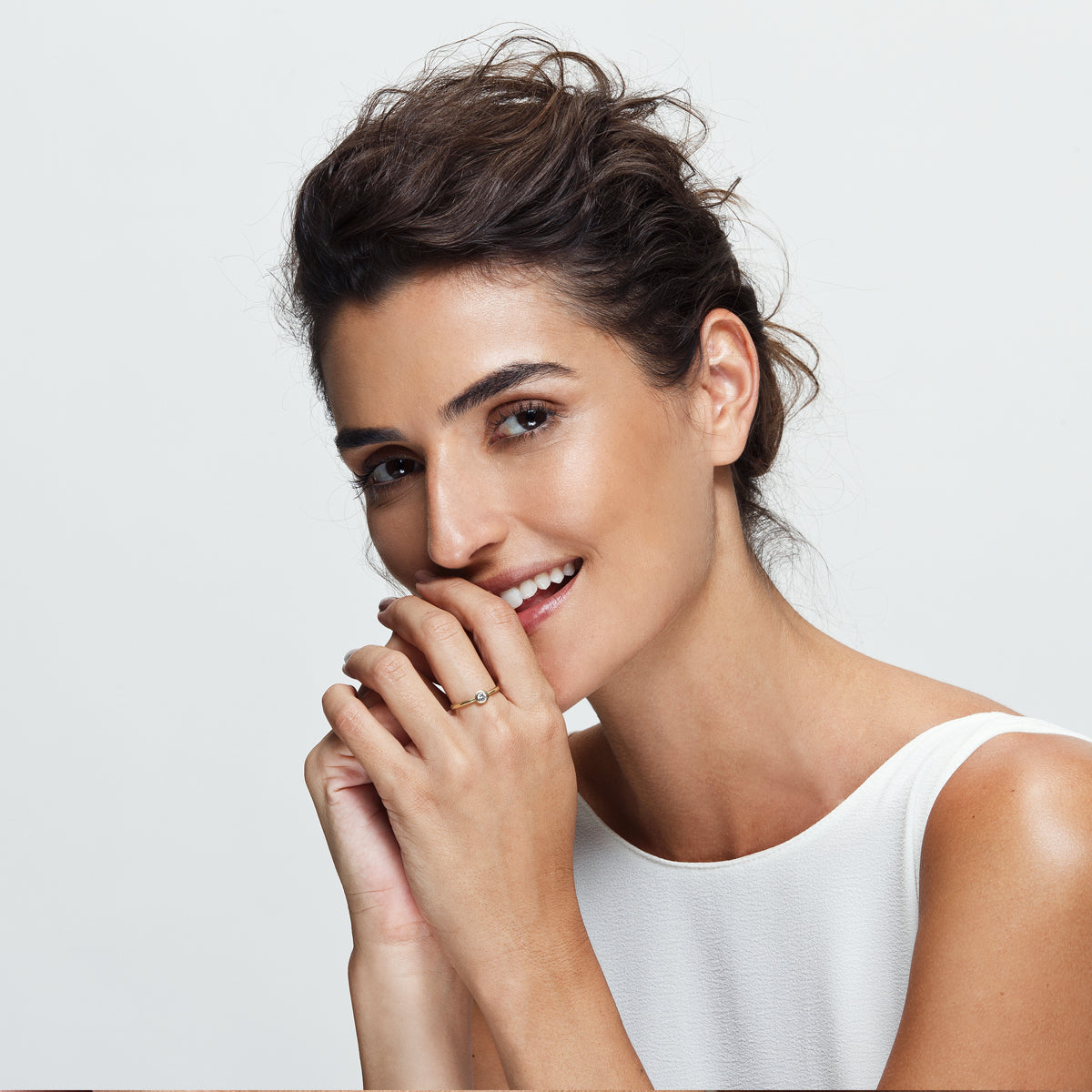 A solitaire diamond ring in a cup setting