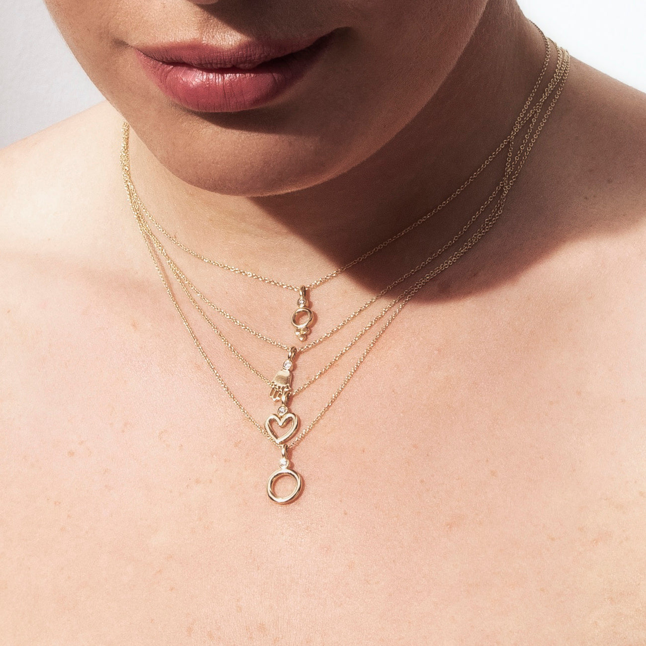 Delicate hamsa necklace set with a diamond