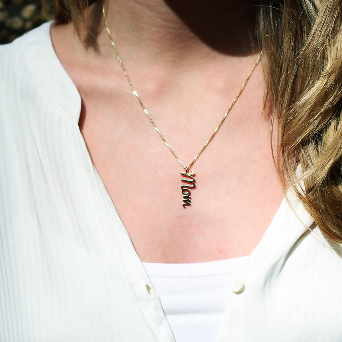 Gold necklace with vertical name pendant