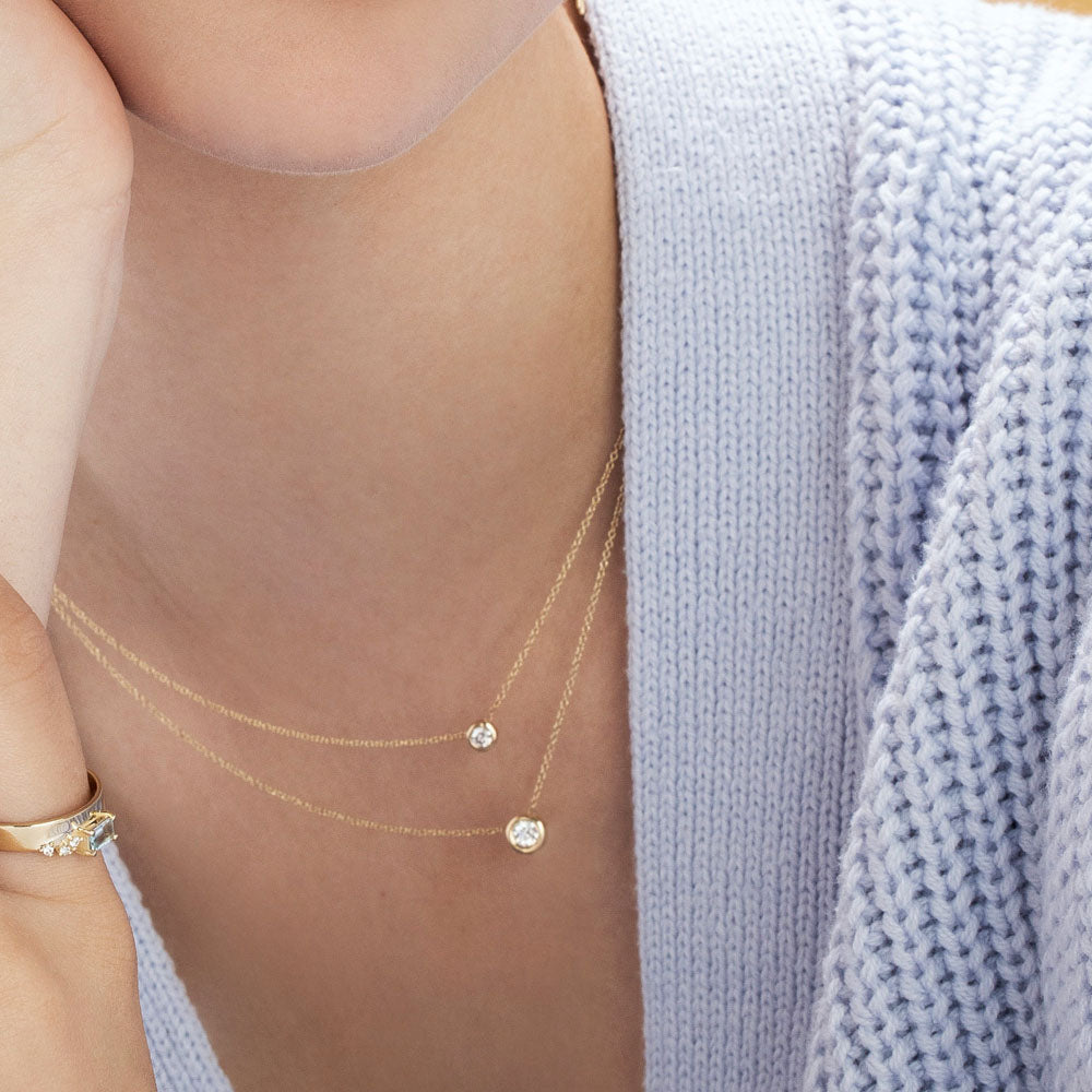 Gold necklace with a diamond pendant in a cup setting, attached to the chain on both sides, 0.15ct diamond