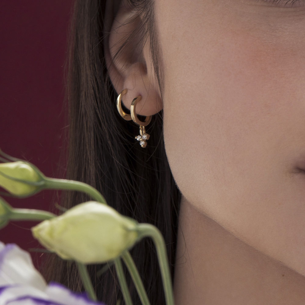 Small attached gold hoop earrings in the shape of a drop