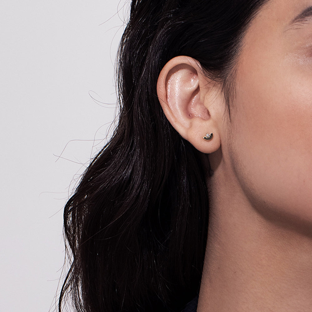 Gold earrings, tight, small, in the shape of a semicircle, set with a diamond