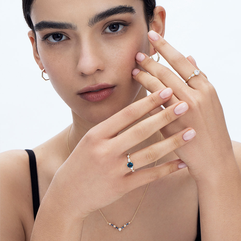 An impressive diamond ring set with a central round diamond combined with drop and marquise cut diamonds