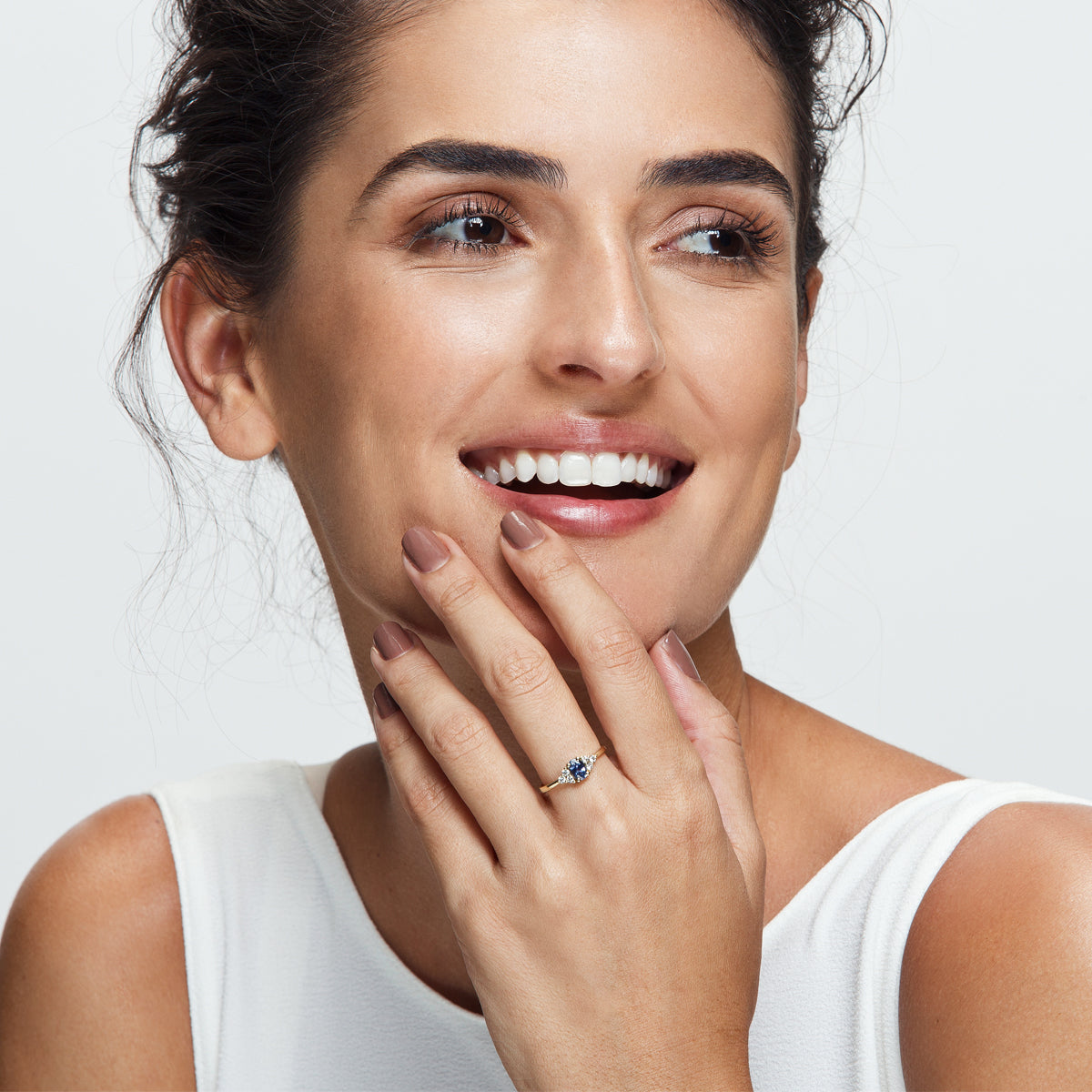 An engagement ring set with an oval-shaped sapphire and 6 sided diamonds