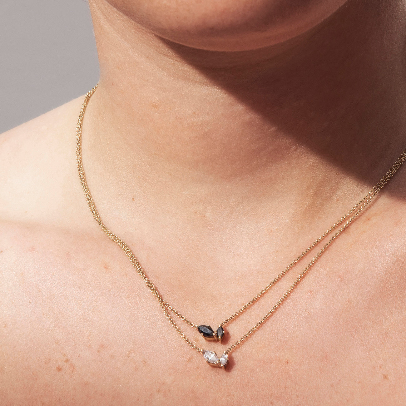 A delicate gold chain inlaid with two marquise-cut diamonds of different sizes
