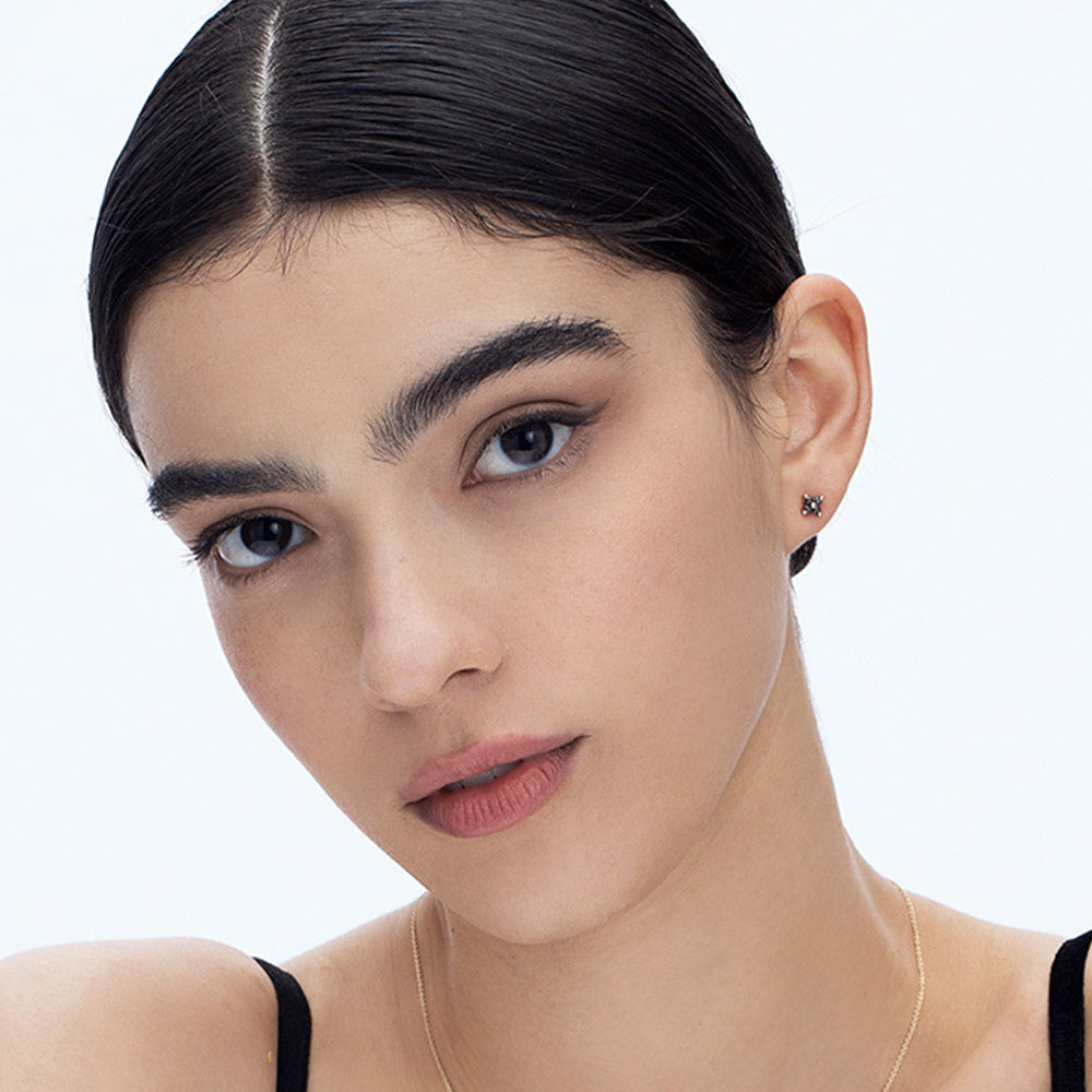 Tight gold earrings studded with 4 black diamonds