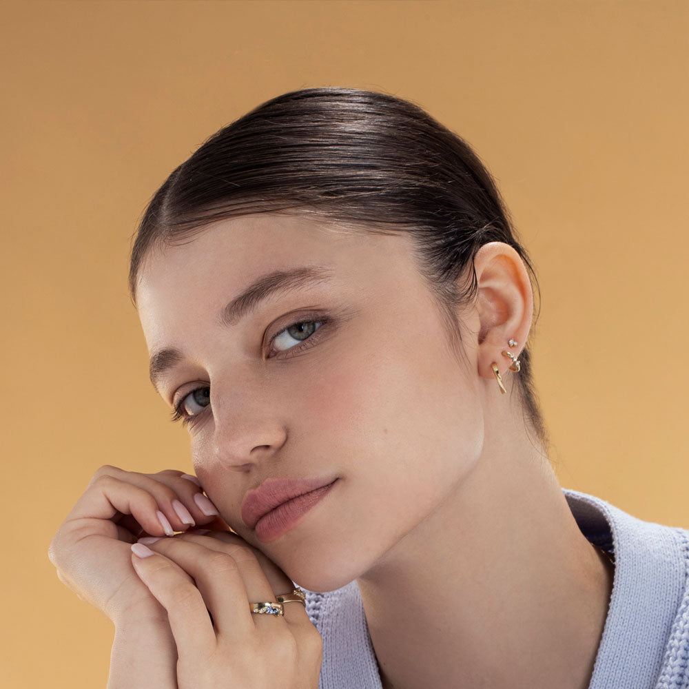 Small gold hoop earrings with a special setting of 3 white diamonds in each earring