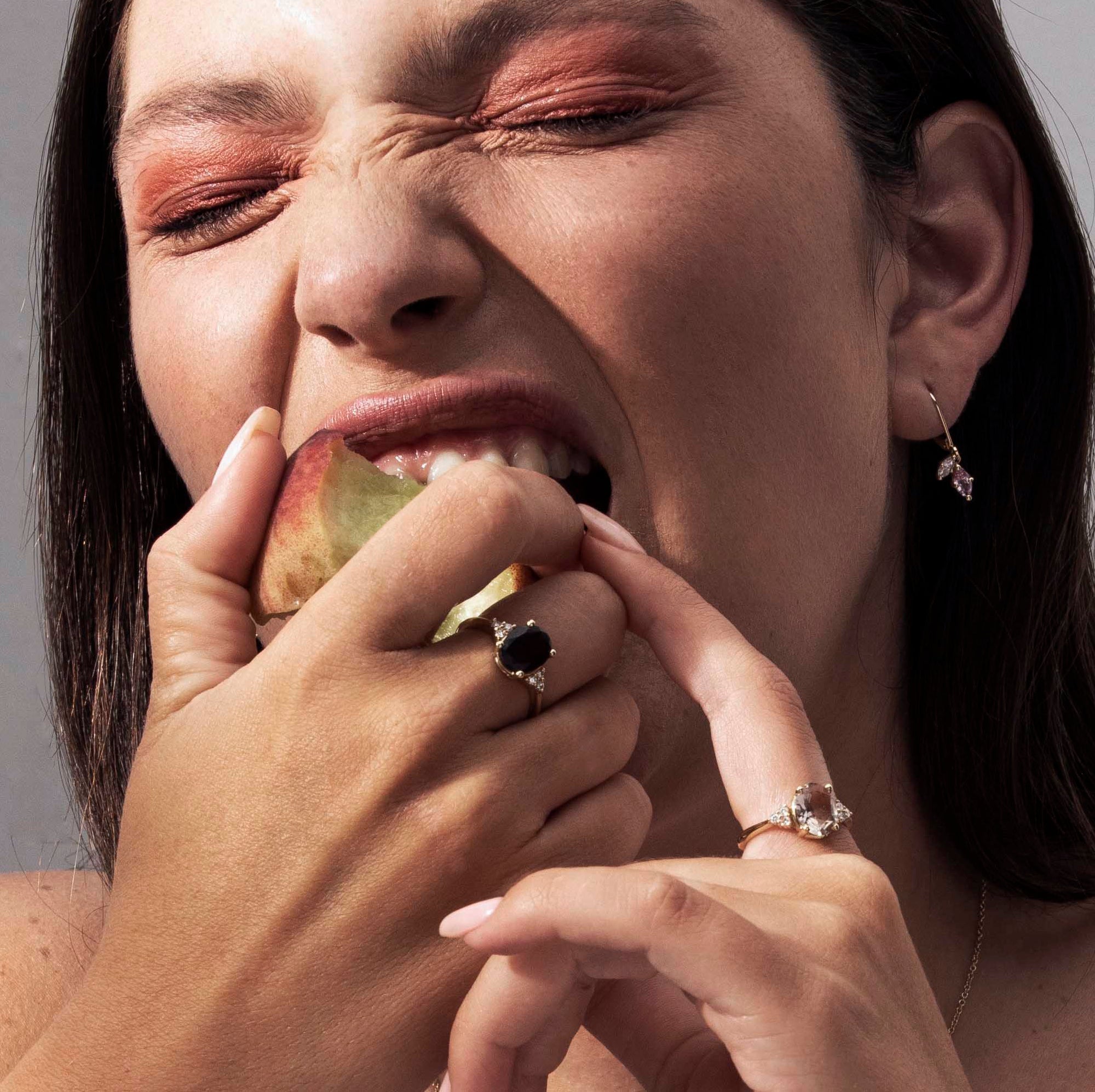 Gold ring set with light smoky quartz in an oval cut and diamonds