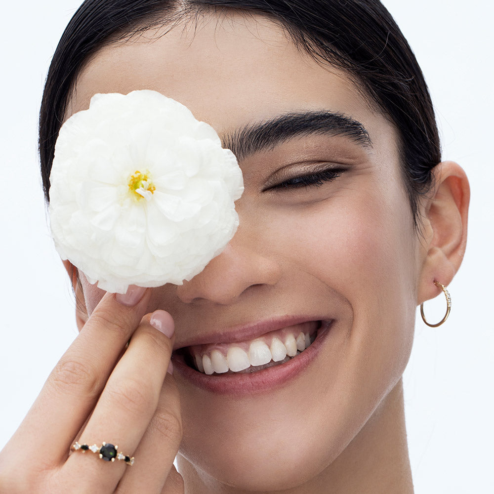 Delicate gold hoop earrings set with a row of 5 diamonds of different sizes