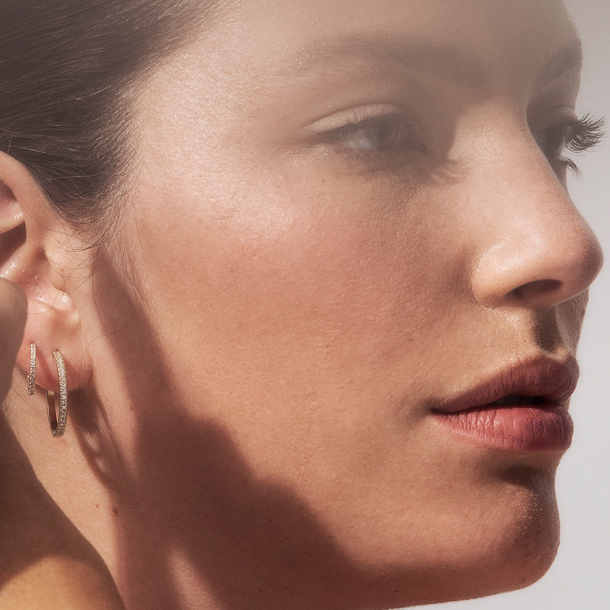 Thin hoop earrings studded with white diamonds