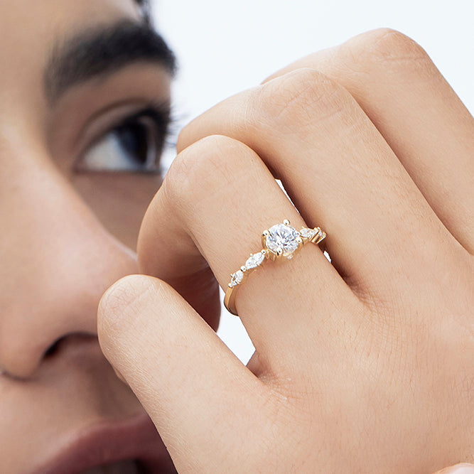 Engagement ring set with a central round diamond 0.60 carat and marquise diamonds