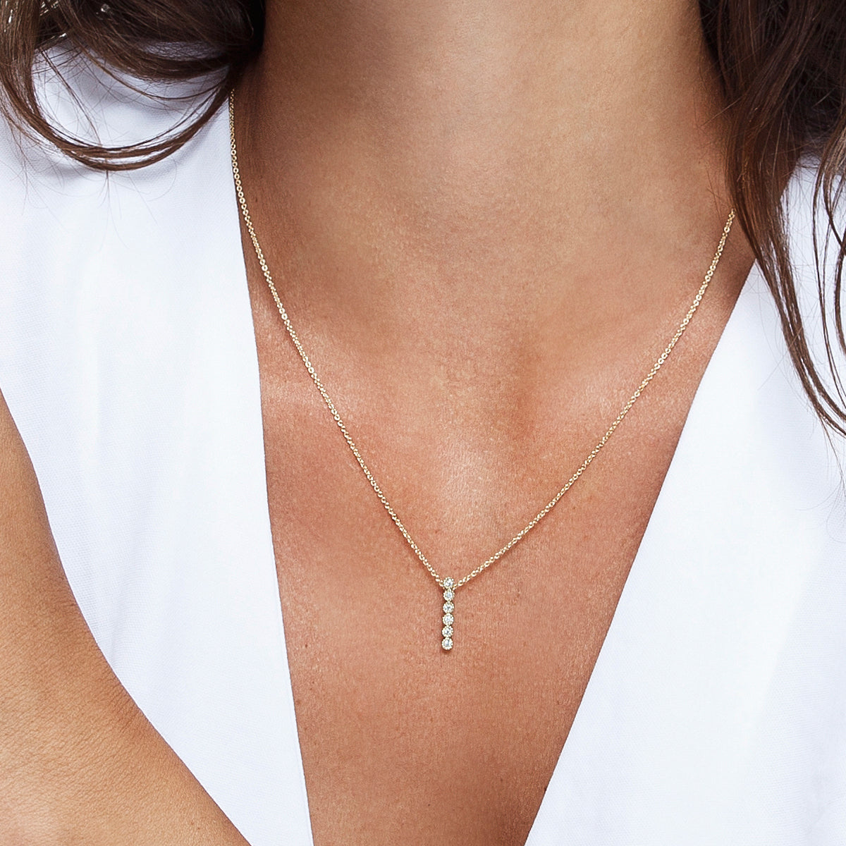 A gold chain and a row of diamonds