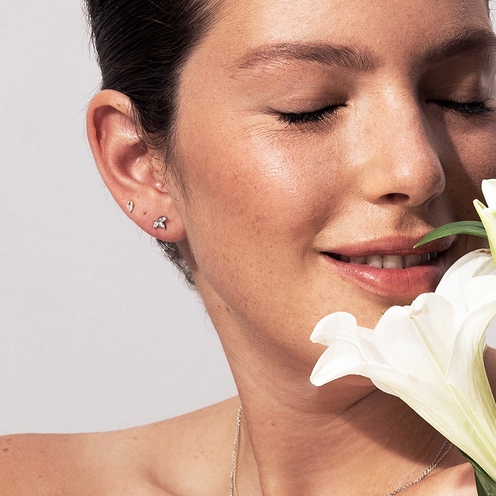 Gold solitaire earrings studded with marquise-cut diamonds