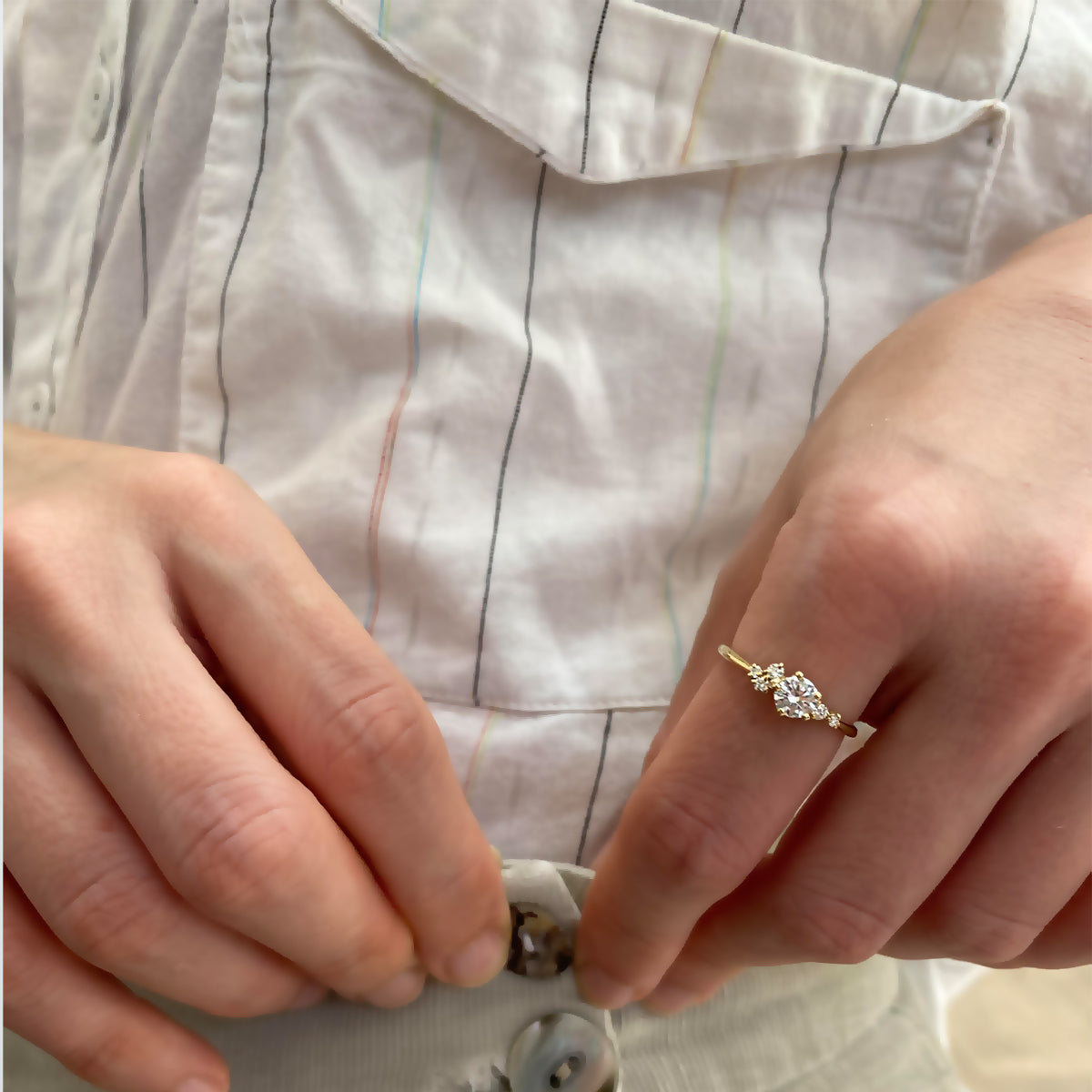 An engagement ring set with a half carat diamond and small asymmetric diamonds
