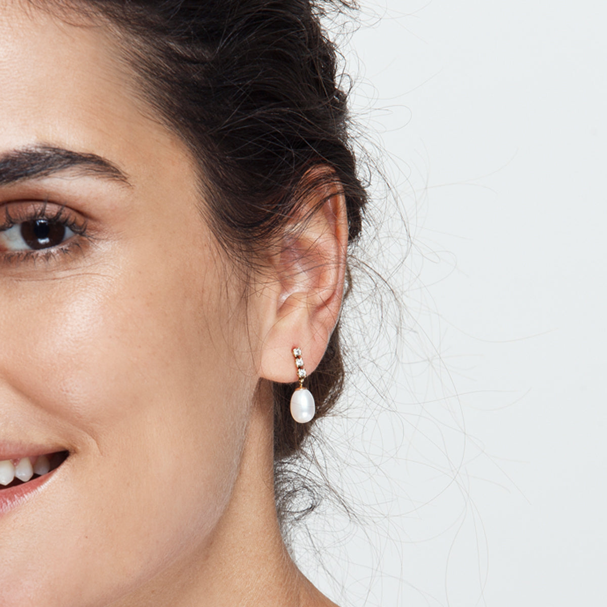Diamond and pearl earrings hanging from gold
