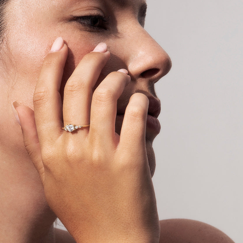 An engagement ring set with a half carat diamond and small asymmetric diamonds