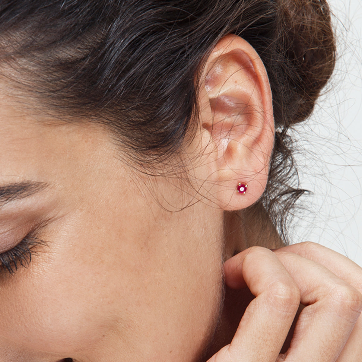 Gold solitaire earrings studded with ruby stones