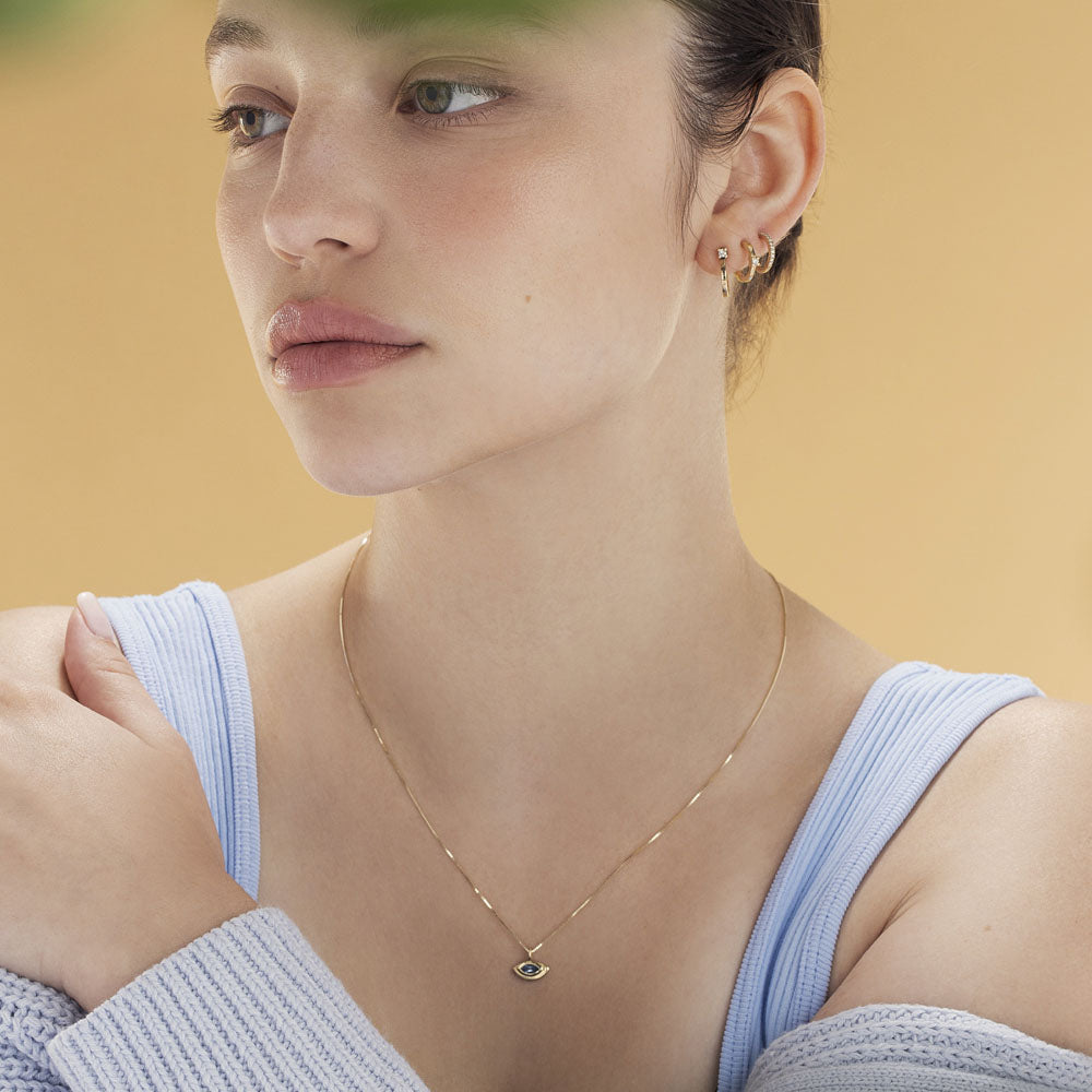 The evil eye pendant with a modern twist in aqua marine inlay