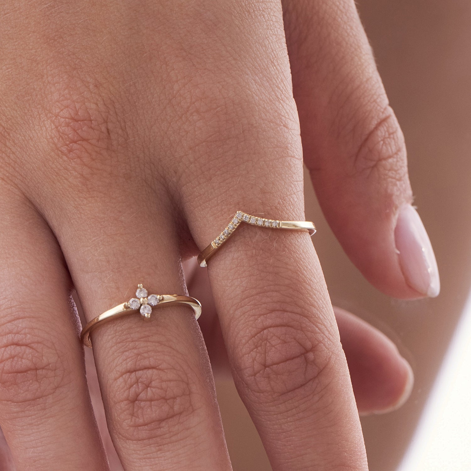 A delicate V gold ring studded with diamonds