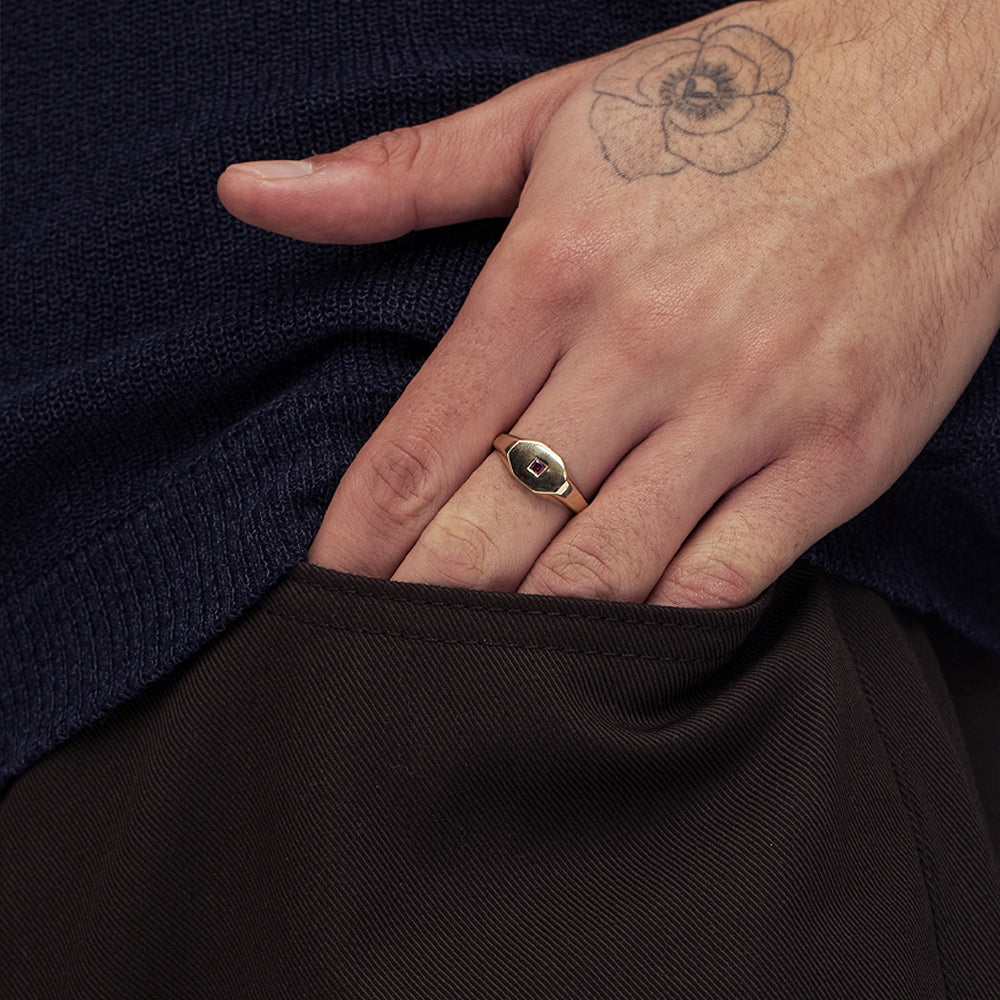An octagon-shaped signet ring for men, set with princess-cut rubies