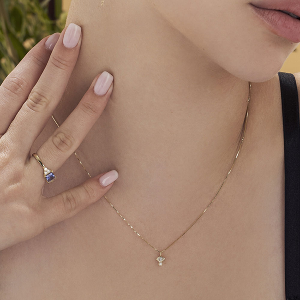 A fine gold chain with a diamond pendant in combination with a marquise-cut diamond (7 points) and a round diamond