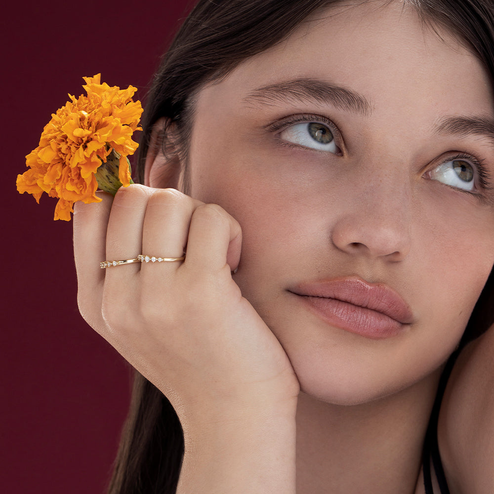 A delicate diamond ring set with 5 diamonds in a special setting