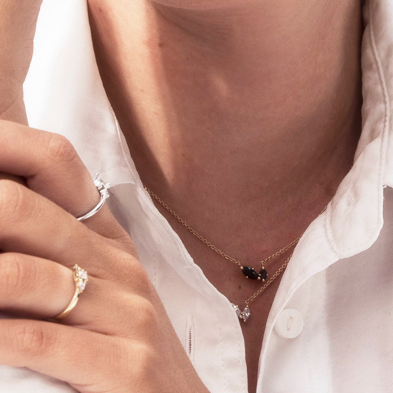 A delicate gold chain inlaid with two marquise-cut black diamonds of different sizes