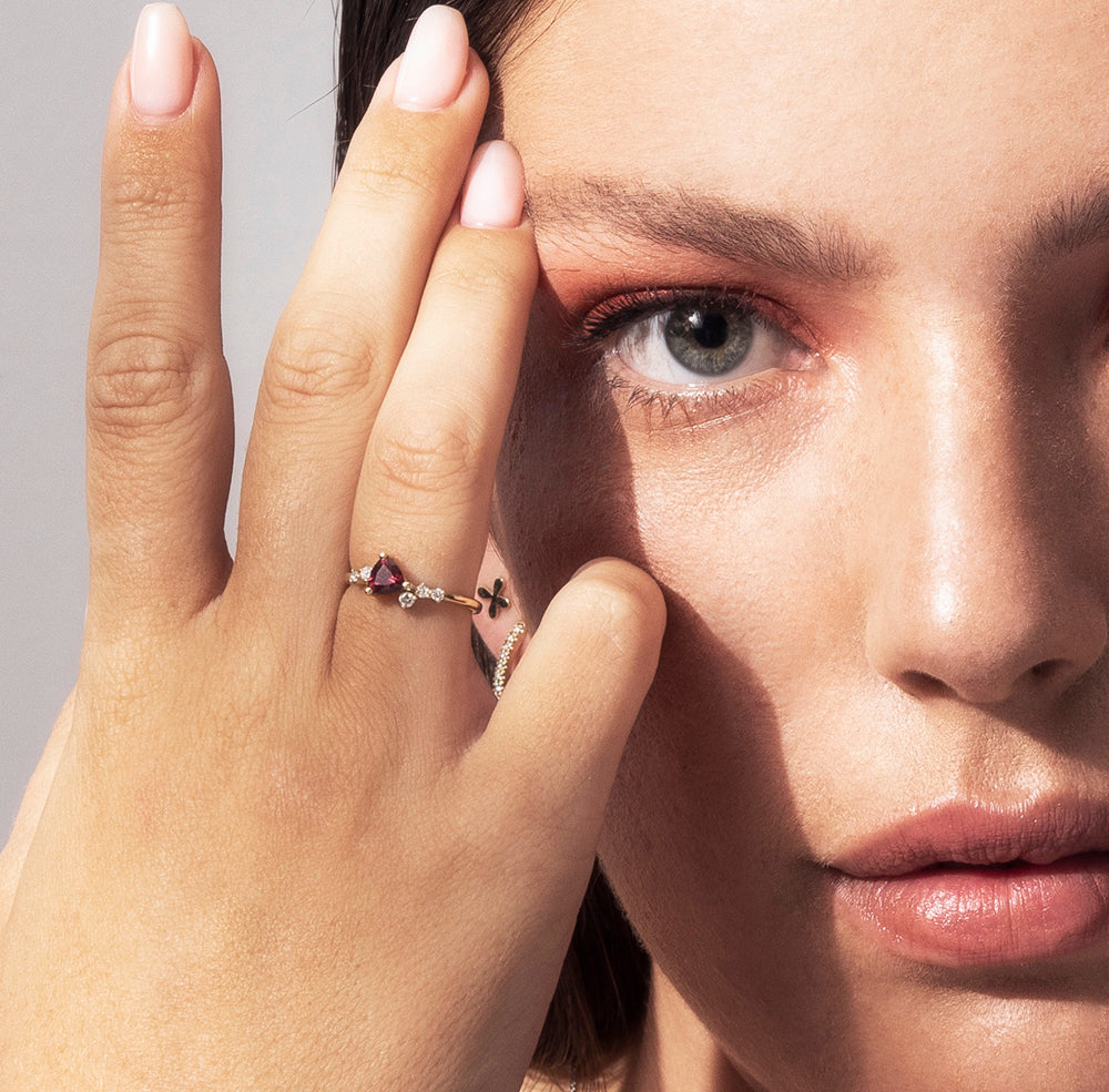 Engagement ring set with trillion-cut rhodolite and diamonds all around