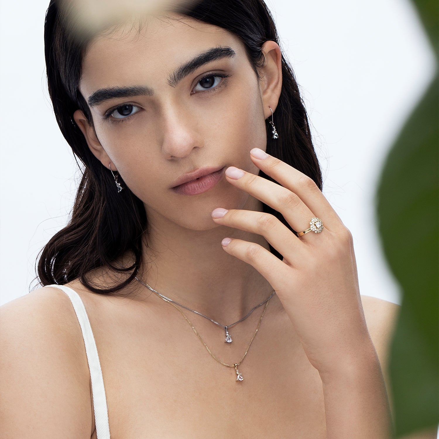 A gold necklace with a trillion-cut morganite inlaid pendant and small diamonds of varying sizes