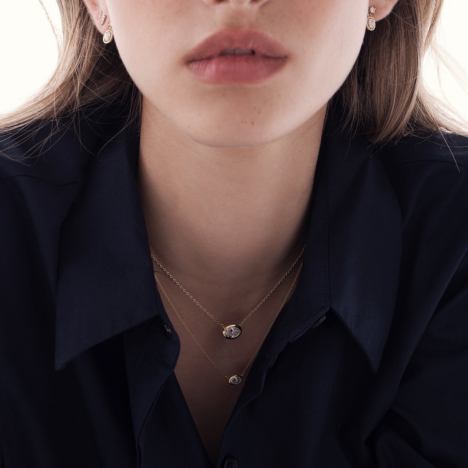 A classic gold necklace set with an oval-cut lab diamond