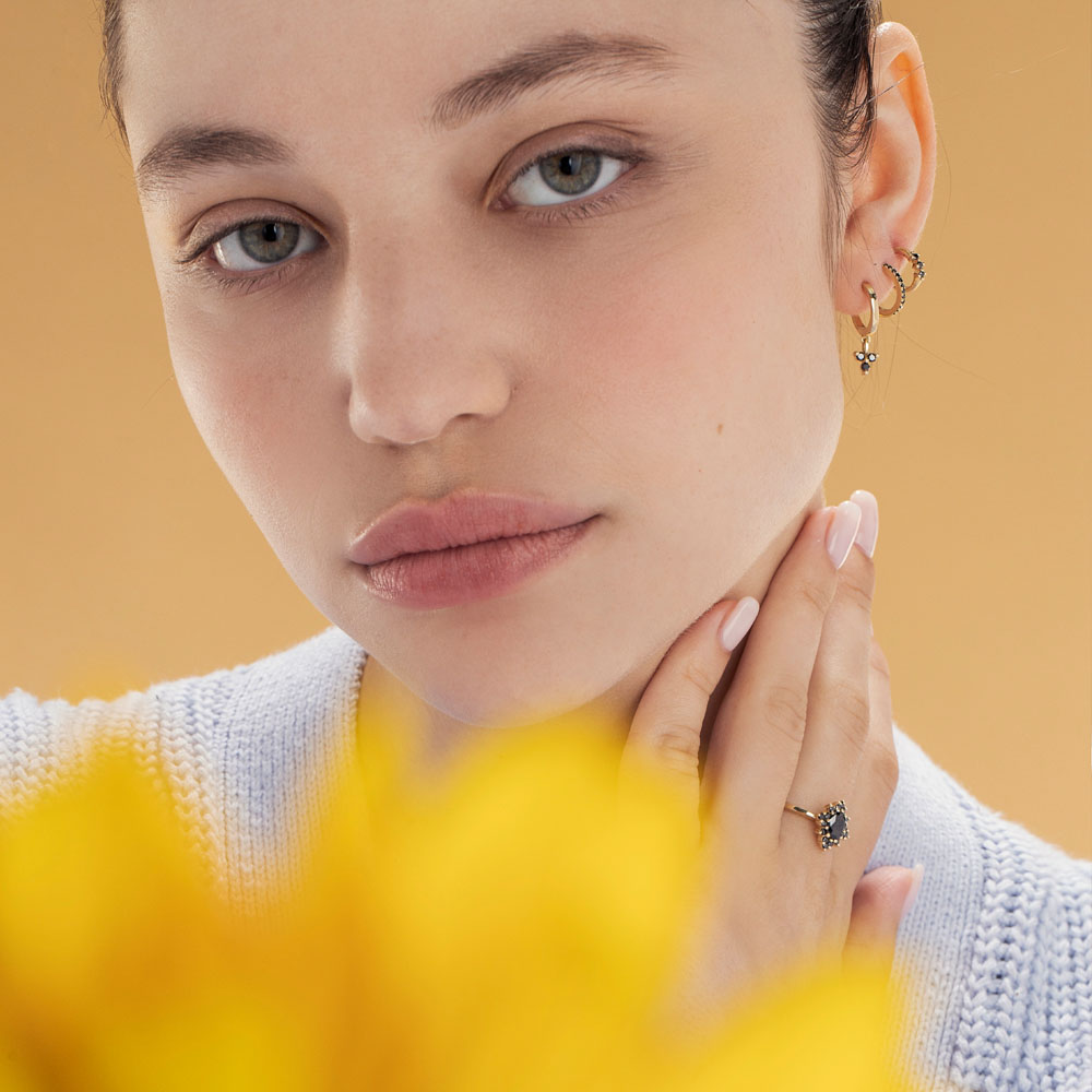 Small hoop earrings with a special setting of 3 black diamonds in each earring