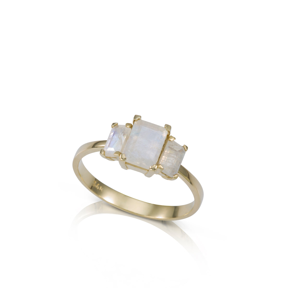 A gold ring inlaid with 3 moonstone stones in a rectangular cut