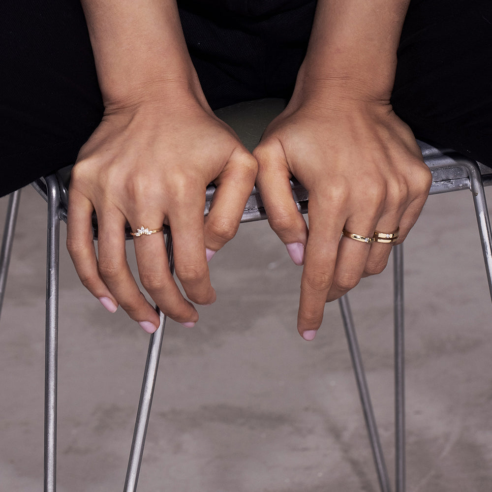 A double gold ring set with a round diamond weighing 5 points