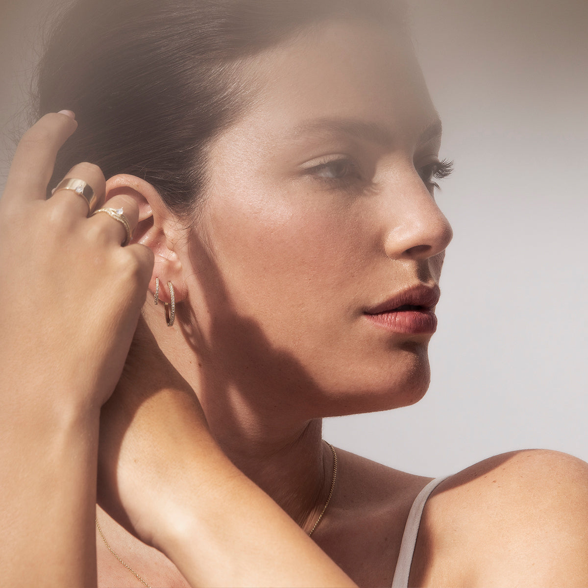 Thin hoop earrings studded with white diamonds