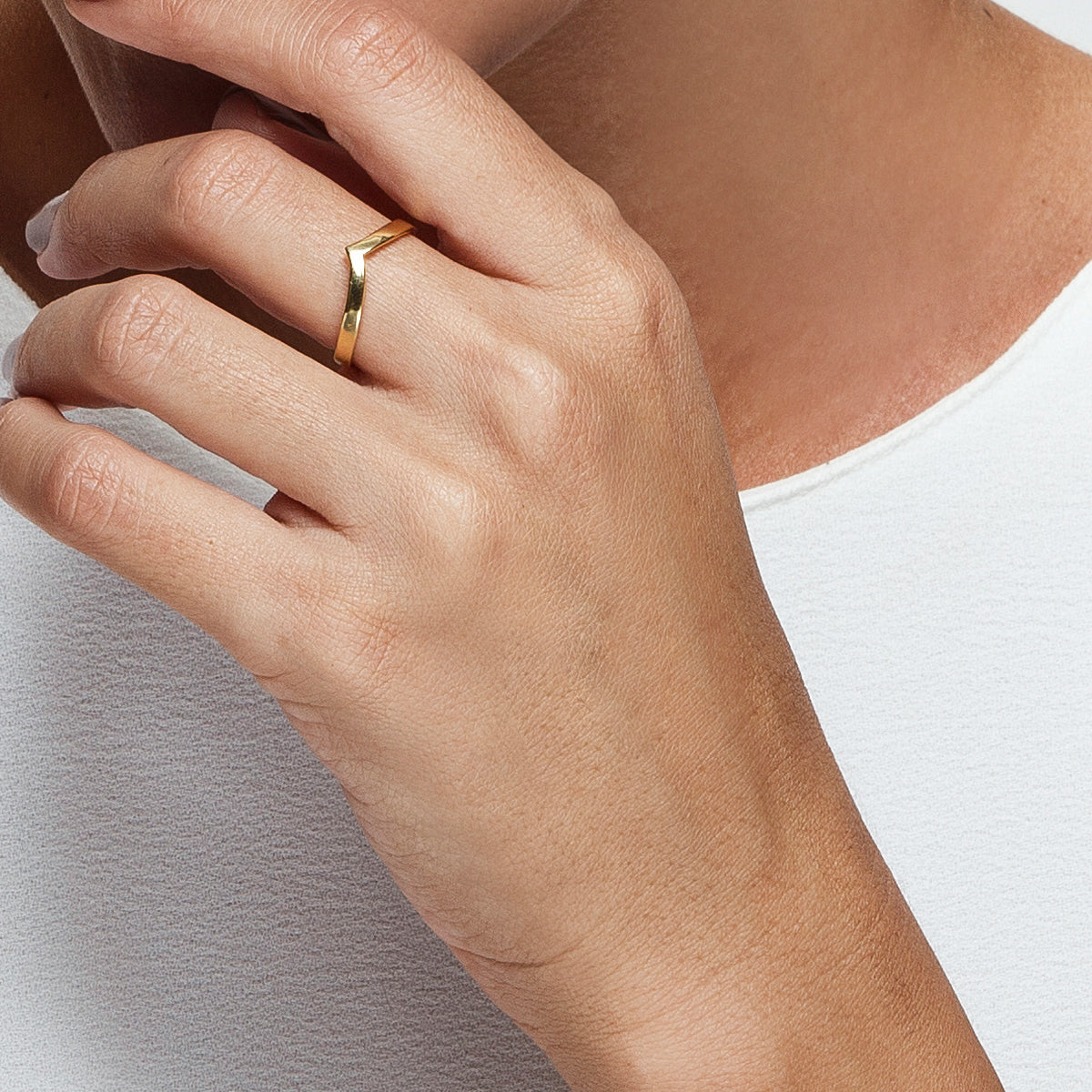 A gold ring in the shape of an arrow