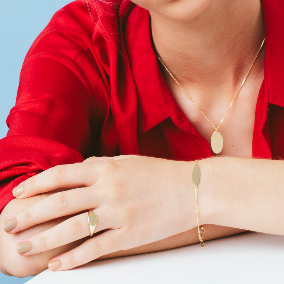 A gold bracelet with an oval engraved name