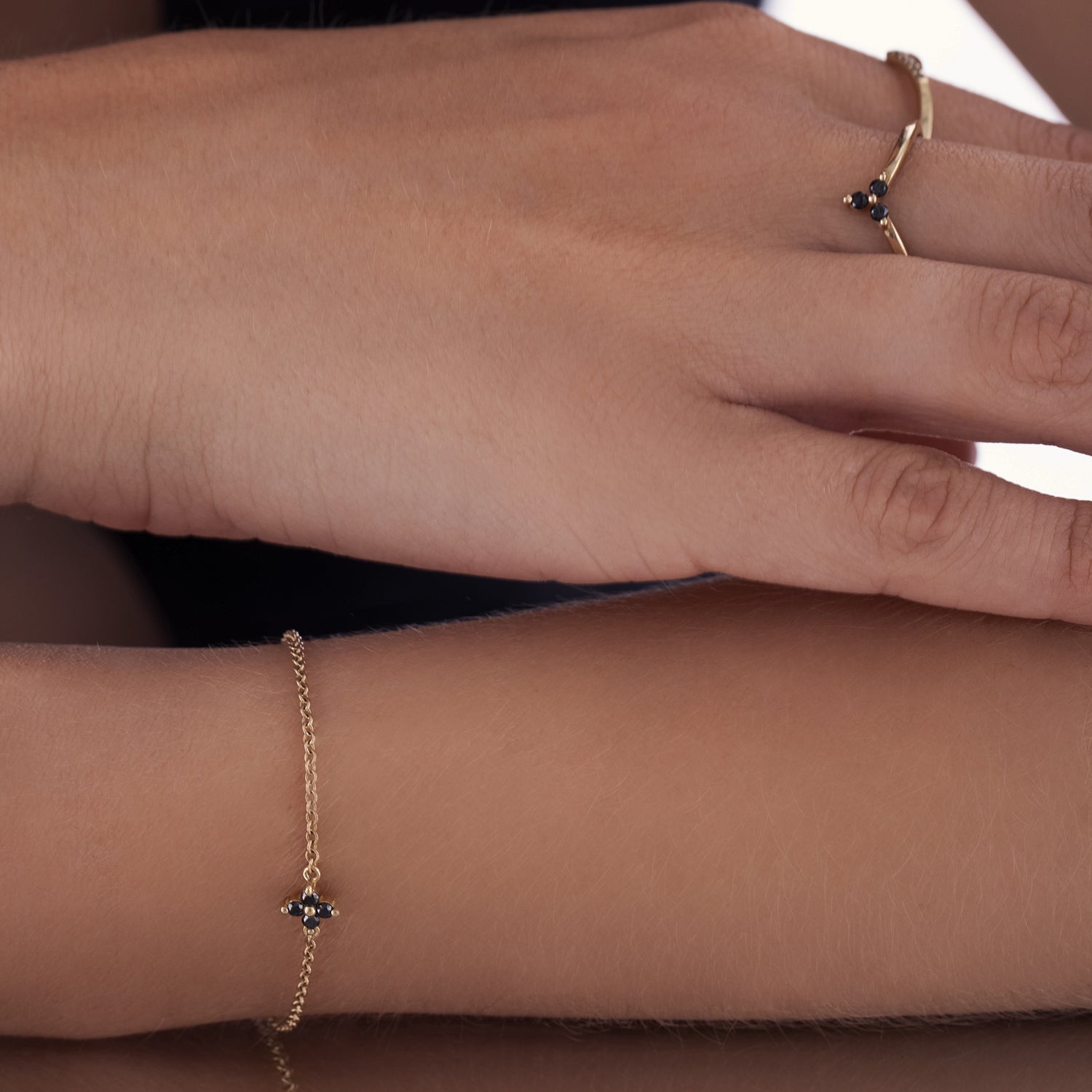 V-shaped gold ring set with 3 black diamonds