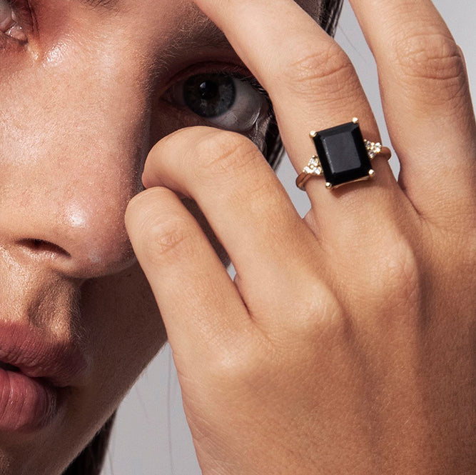 Engagement ring studded with rectangular black onyx and 6 sided diamonds