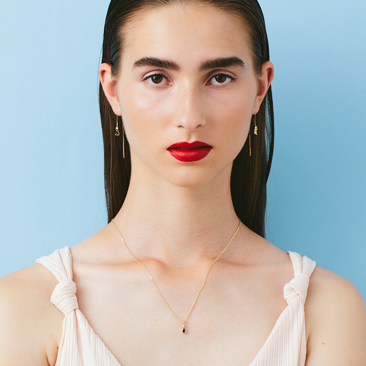 Gold necklace with a drop sapphire and diamond inlaid pendant