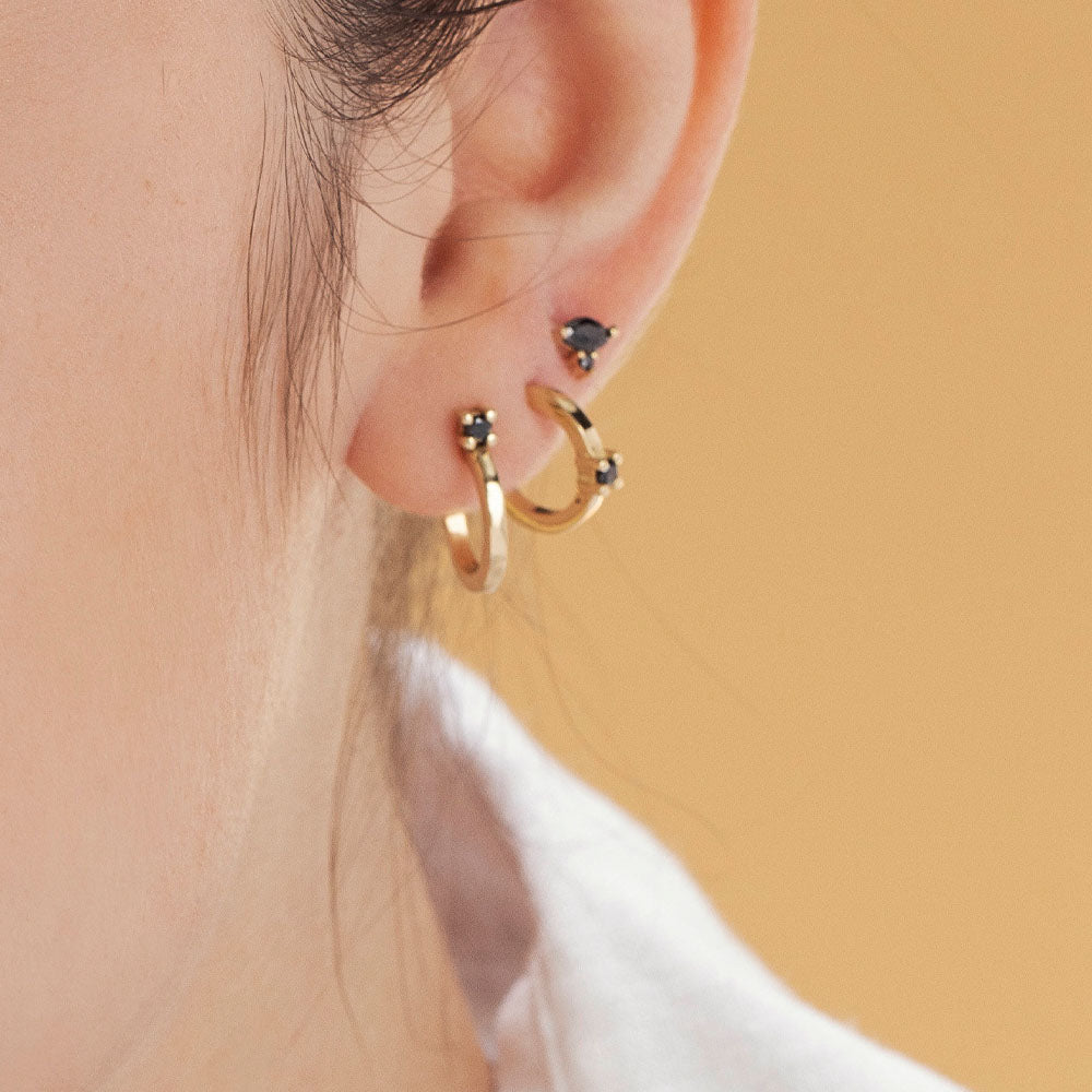 Attached gold earrings and special black diamonds in a marquise and circle cut