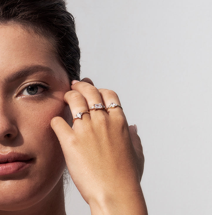 An engagement ring set with a central drop-cut diamond and triangular-cut diamonds on the sides
