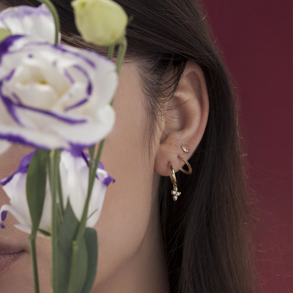 Small attached gold hoop earrings in the shape of a drop