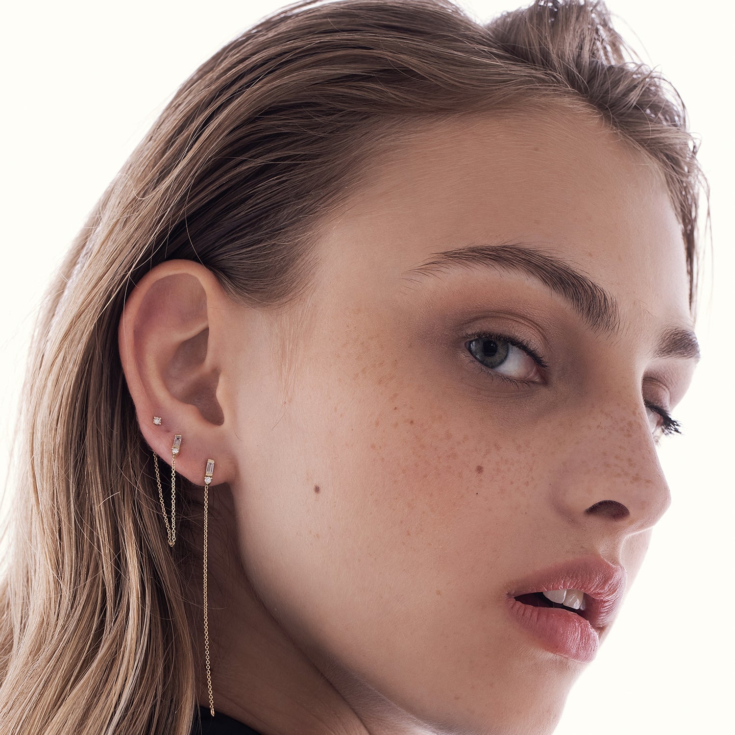 A special gold chain earring set with lab diamonds in a baguette and circle cut