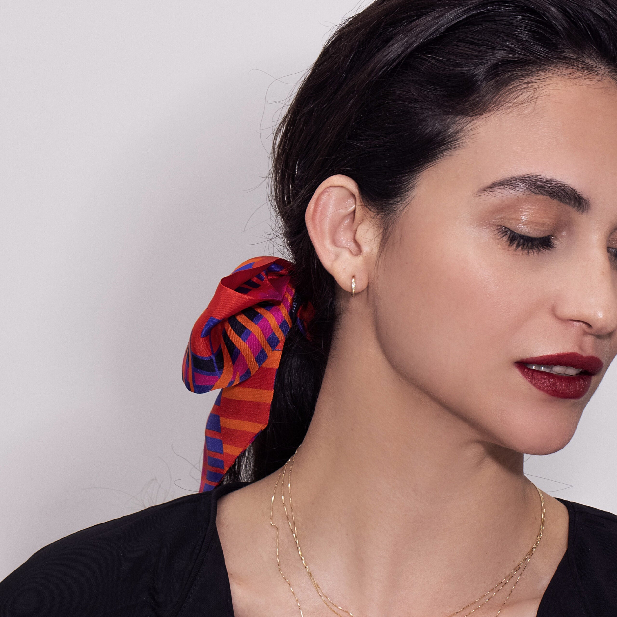 Small gold hoop earrings set with 3 diamonds