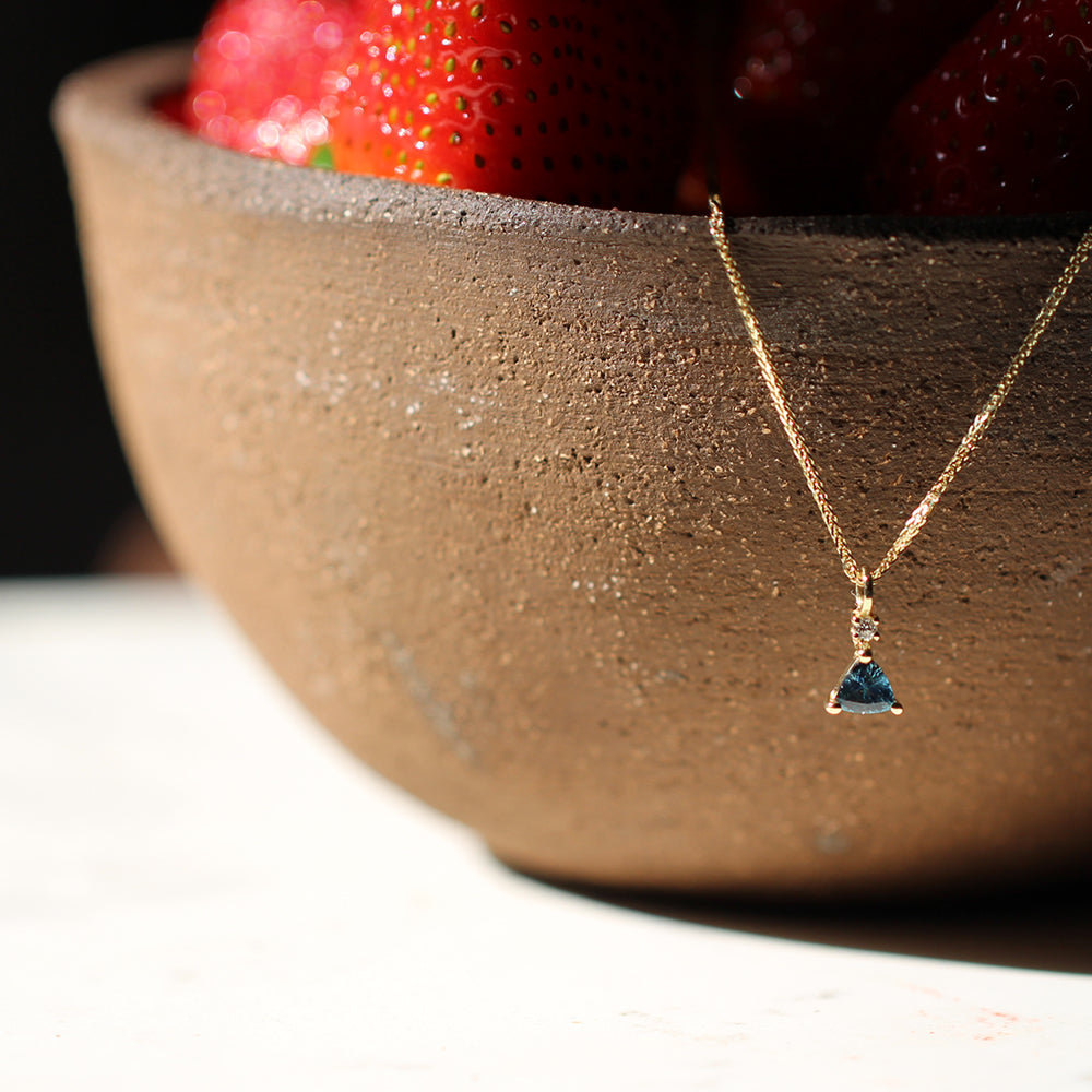 Gold necklace with sapphire and diamond studded pendant
