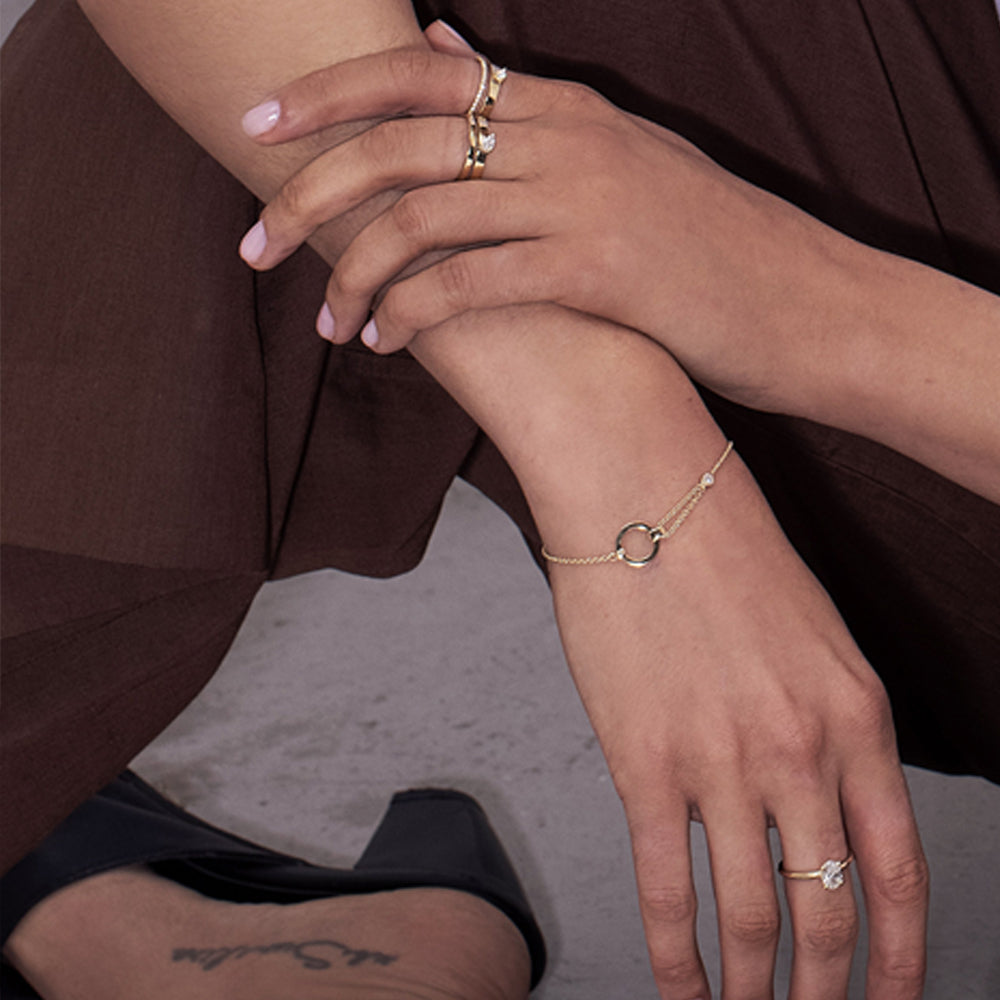 A double gold ring set with a row of diamonds and a drop-cut diamond weighing 10 points