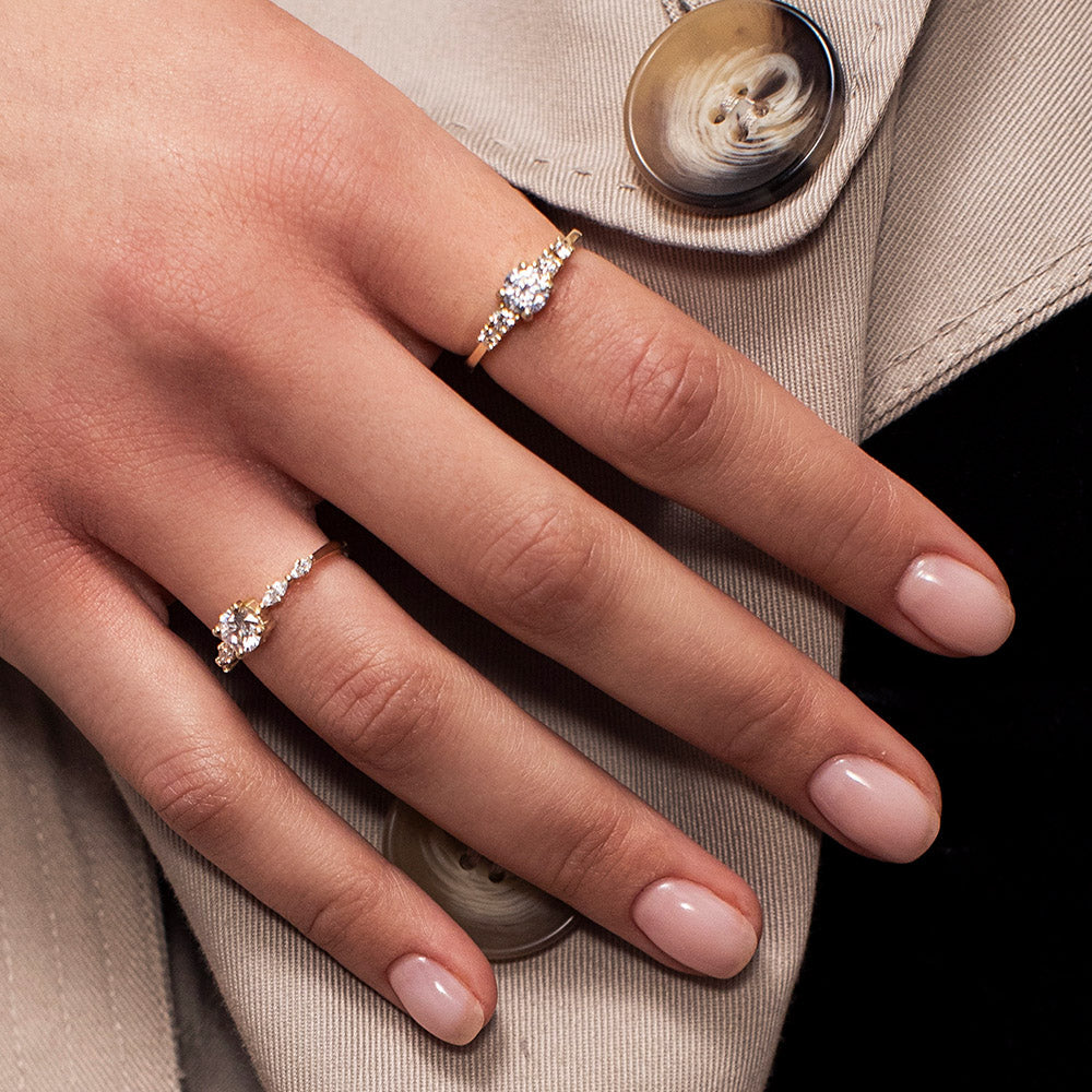 An engagement ring set with a central round lab diamond and 4 side lab diamonds