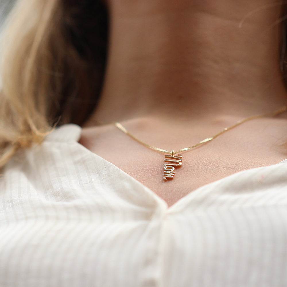 Gold necklace with vertical name pendant